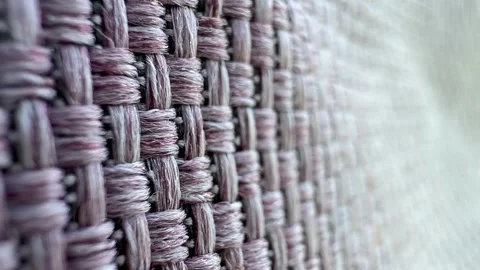 Close-up of woven fabric with a textured pattern. The material features a mix of Stock Footage 324957047