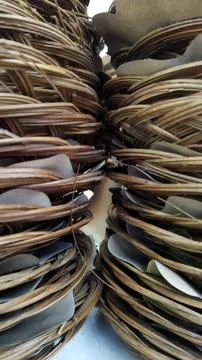 Close-up of woven wicker baskets filled with smooth flat stones in natural li Stock Photos