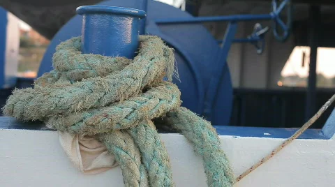 Close up of wraped used ropes on a blue-white anchored boat slightly moving HD Stock Footage 824843
