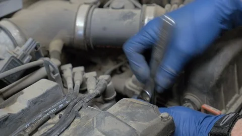 Close-up of a wrench fixing a part on a car engine. Stock Footage