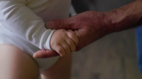 Close up of a Wrinkled Hand of Aged 50s grandfather and Little Palms of baby. Stock Footage 171249903