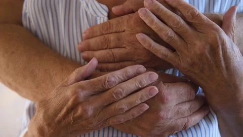 Close up of wrinkled hands Cheerful Elderly couple in love embracing at home Stock Footage 158156137