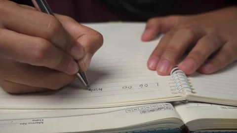 Close up of writing daily routine schedule on book Stock Footage 276807818