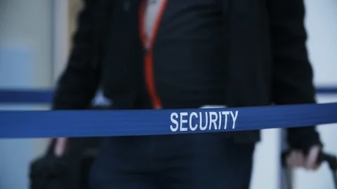 Close-up writing security on blue tape barrier at airport Stock Footage 120689395
