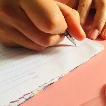 Close-up writing on white paper. Stock Photos