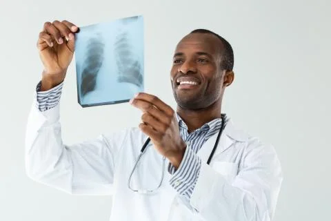 Close up of X-ray scan in hands of positive doctor Stock Photos