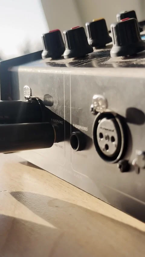 Close-up of an XLR plug being inserted into an audio intercom unit, showing Stock Footage 337739045