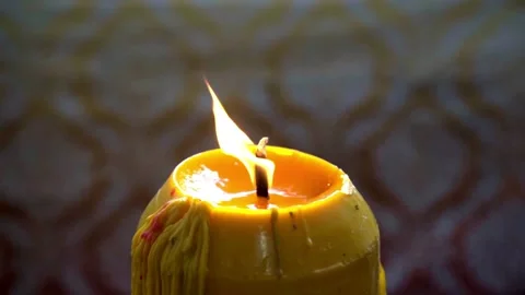 Close up of a yellow candle burning with flame Video stock 331990365