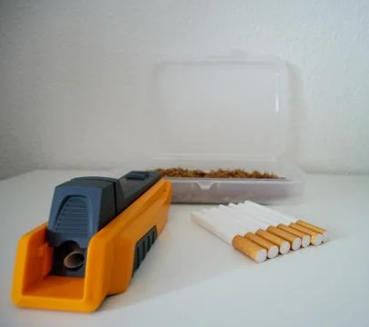 Close-up of a yellow cigarette injector machine, empty filter tubes Фото