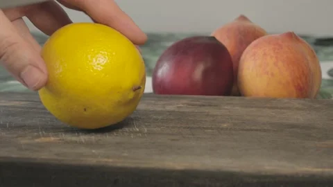 Close up of yellow fresh lemon cut in slices with knife Stock Footage 134069218
