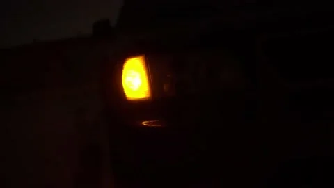 Close-up of the yellow front right light flashing on the car. Stock Footage 144080459