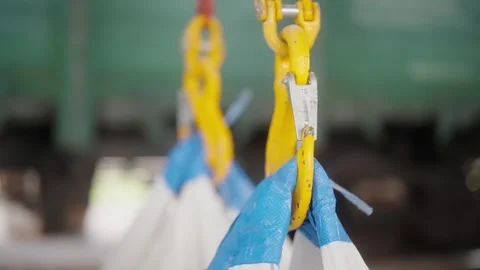 Close-up of yellow hook from crane cathead in the factory workshop, warehouse Stock Footage 273659552