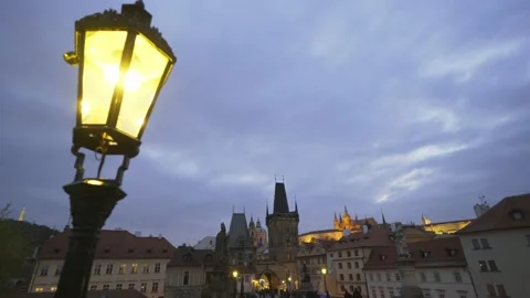 Close yellow lantern against old city square with tourists Stock Footage 143380445