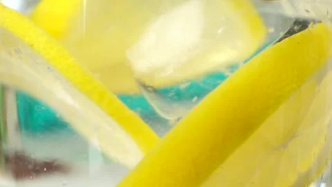 Close-up of yellow lemonade with ice cubes Video stock 241090252