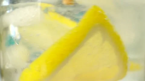 Close-up of yellow lemonade with ice cubes Video stock 241090415