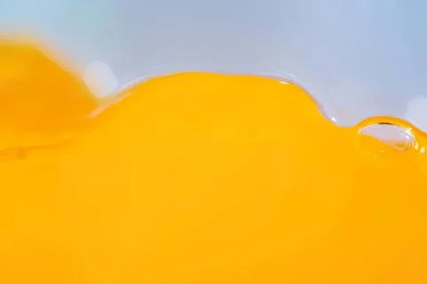 Close-up of a yellow liquid with bubbles and smooth surface Stock Photos
