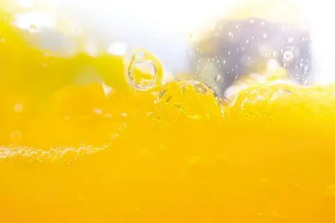 Close-up of yellow liquid with bubbles and reflections Stock Photos