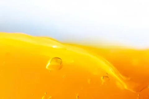 Close-up of yellow liquid with bubbles and smooth surface Stock Photos
