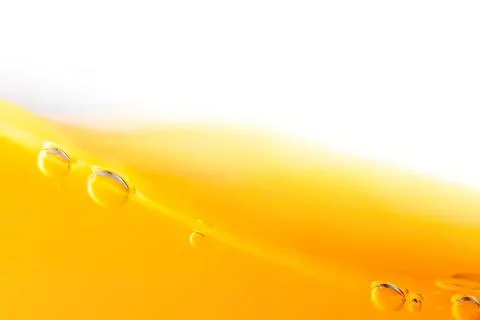 Close-up of yellow liquid with bubbles and smooth surface Stock Photos