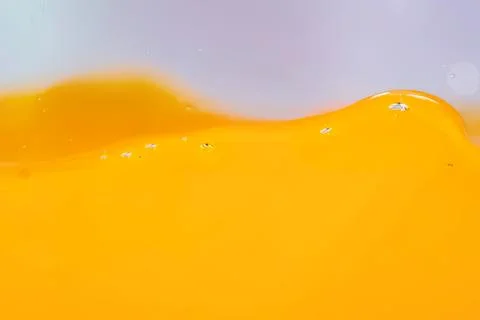 Close-up of yellow liquid with bubbles and smooth surface Stock Photos