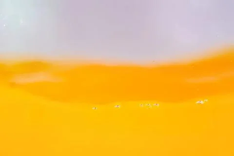 Close-up of yellow liquid with bubbles and smooth texture Stock Photos