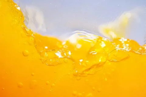 Close-up of yellow liquid splash with bubbles and waves Stock Photos
