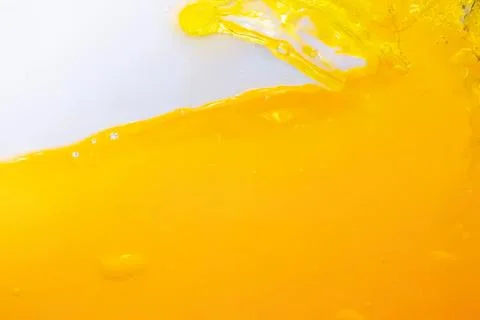 Close-up of yellow liquid splash with white background Foto stock
