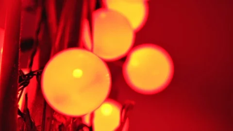 Close up of yellow mate spherical bulbs decoration in red lighting Stock Footage 123217318