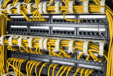 Close up of yellow network cables connected to switch Stock Photos