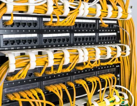 Close up of yellow network cables connected to switch Stock Photos