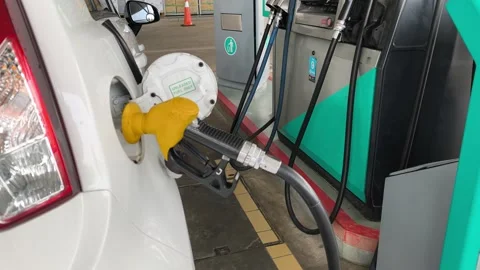 Close Up of Yellow Petrol Nozzle Refueling a Car at Gas Station Stock Footage 331759738