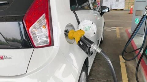 Close Up of Yellow Petrol Nozzle Refueling a Car at Gas Station Stock Footage 331759850