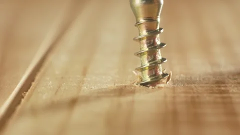 Close-up yellow self tapping screw screwing into wooden surface. Macro view Stock Footage 311988033