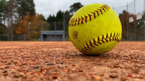Close Up Yellow Softball on Dirt Stock Footage 125224996