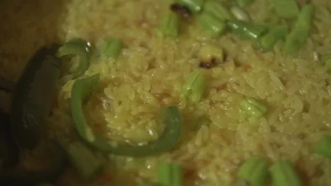 Close up of yellow vegetable rice cooking in a pan Stock Footage 320966683