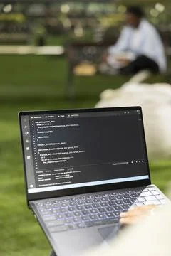 Close up of young adult working on binary code programming with laptop Stock Photos