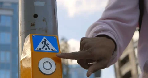 Close up of young afro guy on scooter pressing button of traffic light to safely Vidéo 141449287