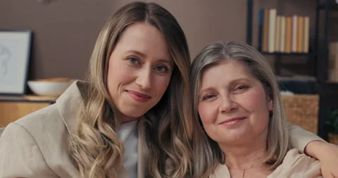 Close-up of young and elderly woman's face. Senior mother with young beautiful 스톡 동영상 218610509