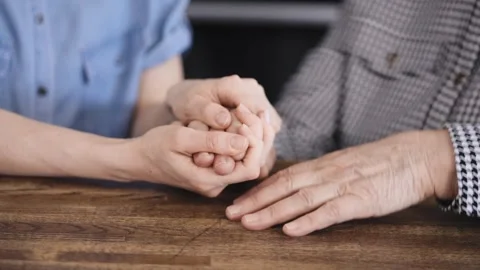 Close-up of a young and elderly woman's hands holding each other. Hands of Stock Footage 246029170