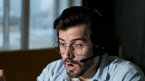 Close Up of a young Angry Man Solving Problems Communicating Online Stock Footage 144372929