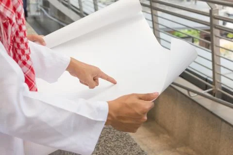 Close up young Arab Middle Eastern Business man team pointing drawing paper Фото