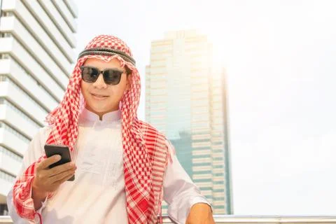 Close up of young Arab Middle Eastern Businessman using mobile smartphone Фото
