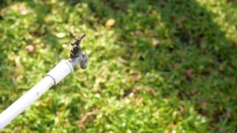 Close up young asian boy taking water from old faucet in the garden.  Stock Footage 73561025