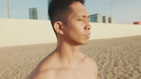 Close up, young athletic man standing on the beach Stock Footage 250844151