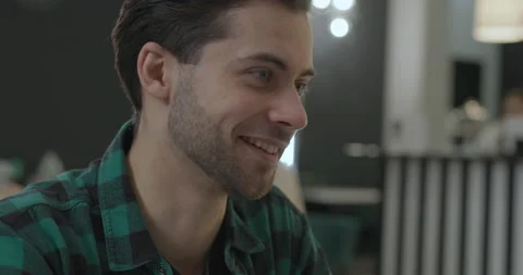 Close-up of a young attractive guy who enthusiastically communicates with a new Stock Footage 150630638
