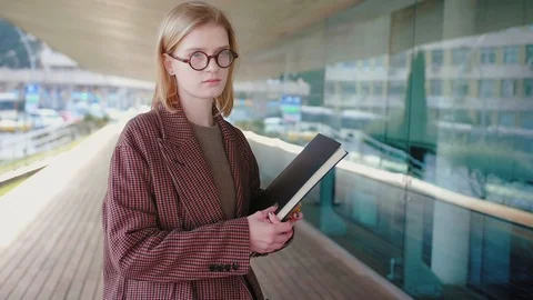 Close up of young attractive trendy student in brown coat and round glasses Video stock 104687136