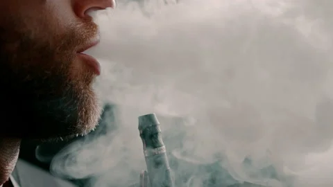 Close up young bearded handsome man smoking hookah thick smoke lounge bar Stock Footage 237980912