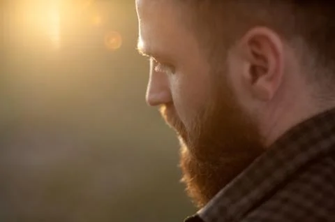 Close-up of a young bearded man with back side view 스톡 사진