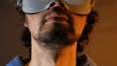 Close-up of young bearded man turning his head around in vr glasses Stock Footage 101405619
