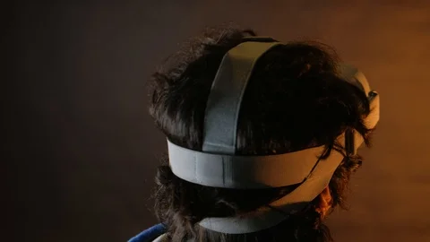 Close-up of young bearded man turning his head around in vr glasses Видео 101405682